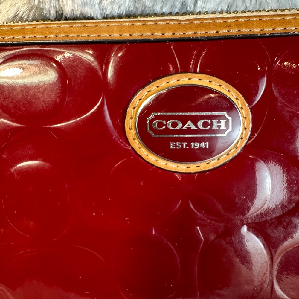 Coach Red Embossed Zippy Wallet with leather trim. $79